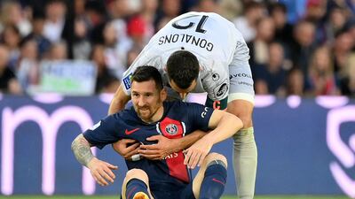 Clermont's Maxime Gonalons helps Lionel Messi to his feet. AFP