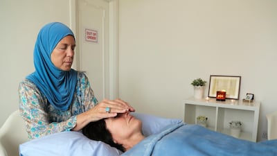 Heidi Elmaarouf practises reiki, which can reduce stress and promote healing. Victor Besa / The National