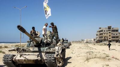 Members of the self-styled Libyan National Army, loyal to the country's east strongman Khalifa Haftar, ride on a tank in the eastern city of Benghazi's central Sabri district on July 5, 2017, during a military operation to retake the last remaining neighbourhood under extremist control. AFP