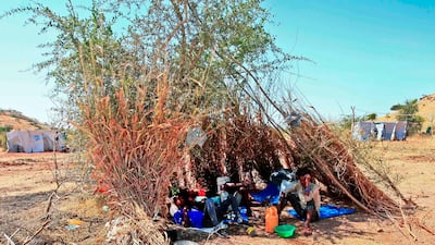 Ethiopian refugees who fled fighting in Tigray province lay in the shade in a straw shack at the Um Rakuba camp in Sudan's eastern Gedaref province. AFP