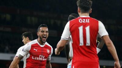 Arsenal's Theo Walcott, left, celebrates his goal against West Ham with Mesut Ozil. Arsenal won 3-0. Frank Augstein / AP