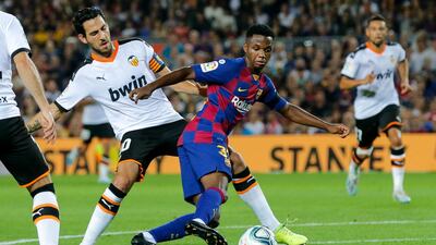 Barcelona´s Guinea-Bissau forward Ansu Fati vies with Valencia's Spanish midfielder Daniel Parejo. AFP