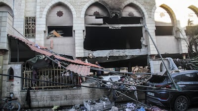 Palestinians inspect the damage following an Israeli strike on the Al-Taba'een school in the Daraj Tuffah neighborhood of Gaza. EPA