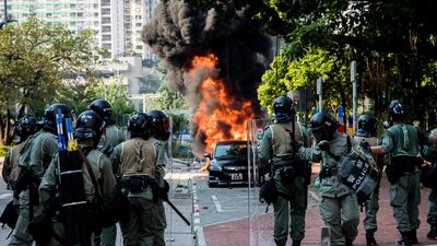As protesters threw Molotov cocktails at the police, one motorcycle caught on fire. The fire swiftly spread to other cars and motorcycles, causing a major fire whose smoke can be seen at least a kilometer away. The police called the fire department to put out the flame. Xun Yuan for The National