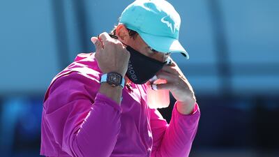 Rafael Nadal of Spain puts on his face mask after winning his first round singles match against Marcos Giron of United States. Getty Images