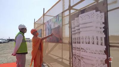 Workers and officials look at plans.