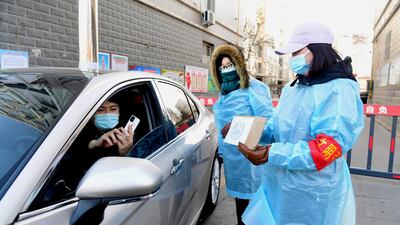 A resident scans a QR code held by a volunteer at the gate of a residential compound in Xinle, following a recent outbreak of the coronavirus disease in Shijiazhuang, Hebei province, China. Reuters