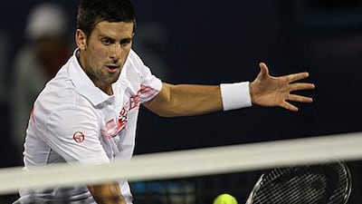 Novak Djokovic returns the ball to Guillermo Garcia-Lopez last night in Dubai.
