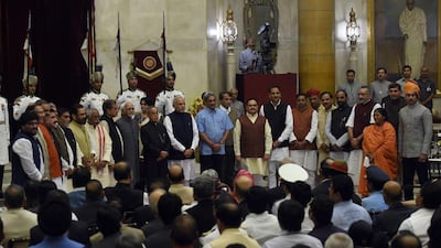 Indian president Pranab Mukherjee, centre left, and Prime Minister Narendra Modi, centre right, pose with new cabinet ministers after a swearing-in ceremony at the Presidential Palace in New Delhi on November 9. Prakash Sigh /AFP Photo