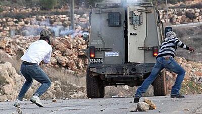 The moment Mustafa, left, was struck by the tear gas canister. He died from his wounds.