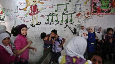 Syrian children play in one of the underground rooms of the Al-Hayat school in Damascus' north eastern rebel-held al-Qaboun surburb. Sameer Al-Doumy / AFP