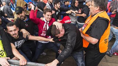 Supporters of Liverpool, right, and Sevilla, left, clash before the Europa League final. Laurent Gillieron / EPA