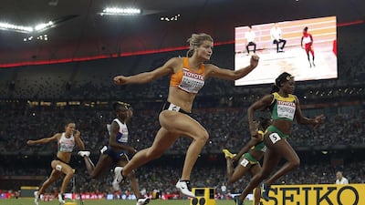 The Netherlands’ Dafne Schippers, centre, crosses the finish line in 21.63 seconds, a European record, to win the women’s 200-metre sprint yesterday at Beijing. Adrian Dennis / AFP