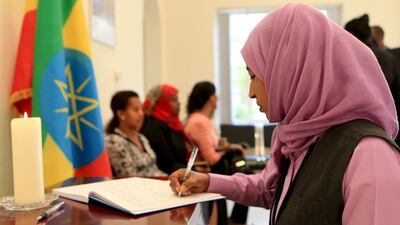 Leyla Shifa Seid adds her name and a message of condolence note in the book at the Ethiopian embassy. Ravindranath K / The National