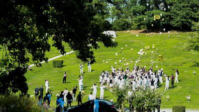 People release balloons at Forest Hills Memorial Gardens cemetery. Reuters