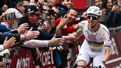 Tadej Pogacar celebrates as he crosses the line. AFP