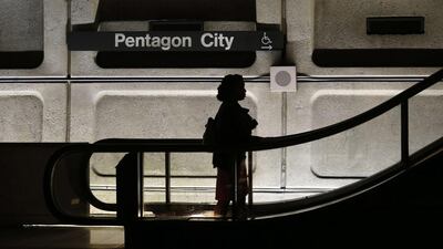 An woman rides an upward escalator at Pentagon City Metro station during rush hour in Washington, as more than a million federal workers were thrown temporarily out of work. Kevin Lamarque / Reuters