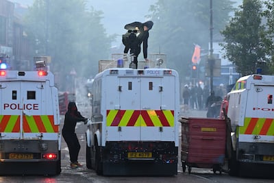 Protestors attack a police vehicle in Belfast. Getty Images