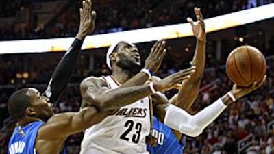 LeBron James scores as he is fouled by Orlando Magic centre Dwight Howard. James ended the game with 37 points.