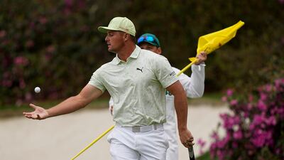 Bryson DeChambeau catches his ball after putting on the 13th green during his second round at the Masters on April 8, 2022, AP