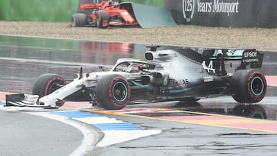 Hamilton rejoins the track after his crash as Leclerc's car sits in the barriers behind. AFP
