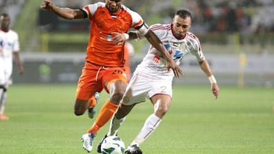 Dubai, United Arab Emirates, May 14, 2013 - Boris Kabi(left), from Ajman, fight for the ball against Khalid Sabeal, from Al Jazira, during the Pro League Etisalat Cup final at Al Wasl's Zabeel Stadium. ( Jaime Puebla / The National Newspaper )