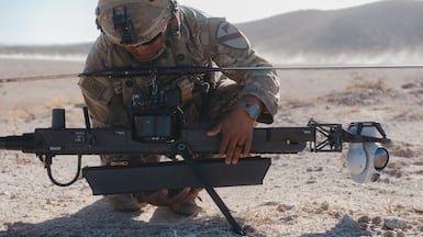 A solider checks an Anduril Industries Ghost-X reconnaissance drone at the National Training Centre in Fort Irwin, California. Bloomberg