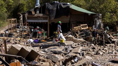A resident walks through debris after Hurricane Helene, in Marshall, North Carolina. Reuters