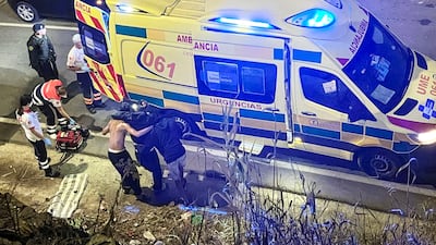 Spanish national police and army members try to resolve a fight among immigrants at Trampolin beach. EPA