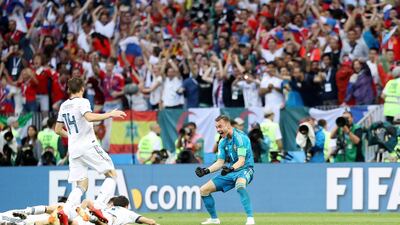 Goalkeeper Igor Akinfeev celebrates with his teammates after his penalty saves put Russia into the quarter-finals of the competition. Mahmoud Khaled / EPA