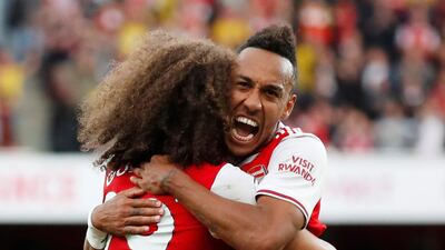 Arsenal's Pierre-Emerick Aubameyang celebrates scoring their second goal against Tottenham Hotspur with teammate Matteo Guendouzi. Reuters