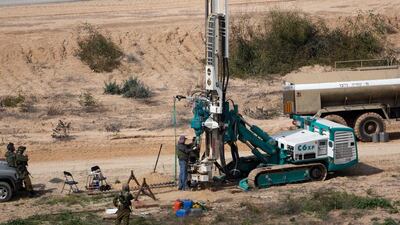 Israeli soldiers keeping watch as a machine drills holes in the ground on the Israeli side of the border with the Gaza Strip as they search for tunnels used by Palestinian militants for fighting Israel. Israel’s military said it had located and destroyed a tunnel extending from the Gaza Strip into Israeli territory. Menahem Kahana / AFP