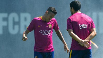 Barcelona’s Brazilian forward Neymar (L) talks with Barcelona’s Uruguayan forward Luis Suarez (R) during a training session at the Sports Centre FC Barcelona Joan Gamper in Sant Joan Despi, near Barcelona on April 16, 2016, on the eve of the final of the Copa del Rey match between FC Barcelona and Sevilla FC. Lluis Gene / AFP