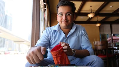 Nikhil Soneja is a champion and head of the UAE Scrabble Club and, as in this cafe in Dubai, is rarely without his board and tiles. He is keen to get more people playing the word game, including an Arabic version. Pawan Singh / The National