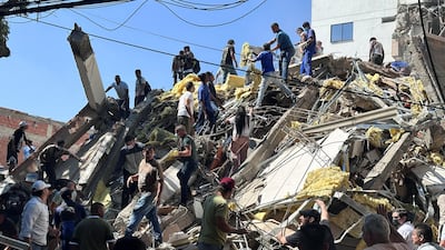 Residents dig through the debris of a collapsed building in Cali, Colombia, after an earthquake. Reuters