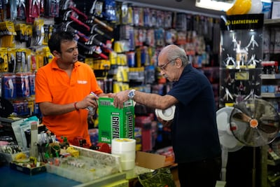 Store employees Ankur Patel and Martin Matio unload a stock delivery at a branch of the Tool Shop hardware stores in the Bayswater area of central London. Millions of people across the UK are facing a bleak winter as the rising cost of living collides with the end of government programmes that once shielded households from the economic fallout of Covid-19. AP