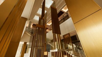 The lobby features marble floor with bronze accents
