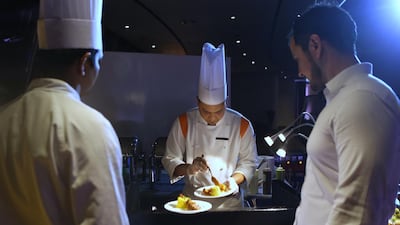 Chef Anuar Mohammed prepares butter chicken. Delores Johnson / The National