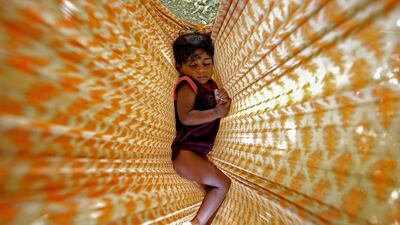 A homeless girl sleeps in a hammock along the roadside in Bangalore. Jagadeesh NV / EPA