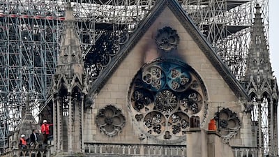 Inspectors are seen on the roof of Notre-Dame Cathedral in Paris, the day after a fire ripped through its main roof. AFP