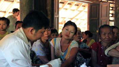 A government health worker takes a blood sample from a woman to be tested for malaria in Ta Gay Laung village hall in Myanmar's southeastern Kayin state on November 28, 2014. Astrid Zweynert/Reuters