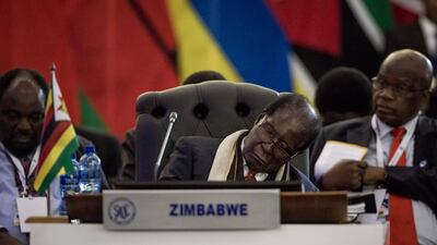 President Robert Mugabe of Zimbabwe rests at the opening session of the 37th Southern African Development Community summit in Pretoria on August 19, 2017. He was not accompanied by his wife Grace, who has been unable to leave South Africa after being accused of assault and is seeking diplomatic immunity. Gulshan Khan / AFP