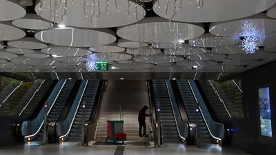 A man cleans the stairs in a deserted shopping mall in the city of Munich, southern Germany. AFP