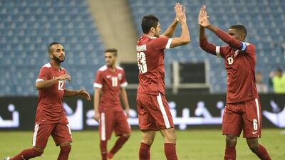 Qatari national team players celebrate after scoring a goal against Saudi Arabia’s national team during the 22nd Gulf Cup football match at the King Fahad International stadium in Riyadh on November 13, 2014. AFP PHOTO/FAYEZ NURELDINE