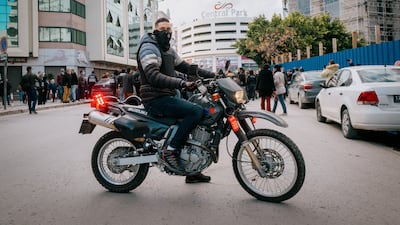 A protestor joins the demonstration on a bike. Erin Clare Brown / The National