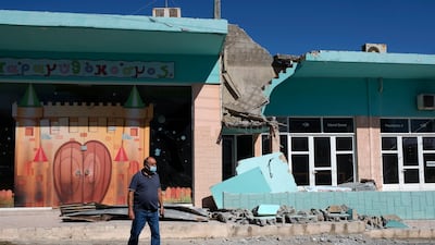 A man stands outside a damaged building after a strong earthquake in Arkalochori village on Crete. Photo: AP