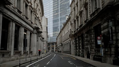 A person walks through empty streets in the City of London during the third lockdown. Associated Press