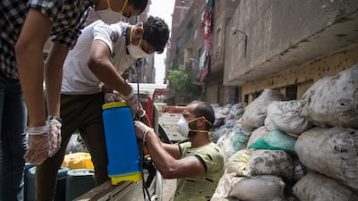A man prepares disinfectant during a civil initiative to sterilise the Zebaalin district in Cairo, Egypt. EPA