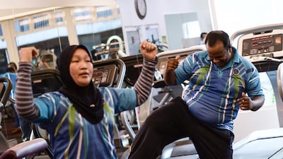 Malaysian police officer Suresh Mariah, right, exercising as he takes part in the special weight-loss fitness programme at the police headquarters in Kuala Lumpur. Suresh is among thousands of Malaysian officers who have been ordered to lose weight amid concern that fast-expanding waistlines could limit their crime-fighting abilities. Manan Vatsyayana/AFP Photo