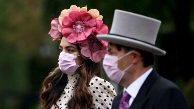 Racegoers wear face masks as they arrive for day four of Royal Ascot at Ascot Racecourse. Steven Paston/PA Wire.